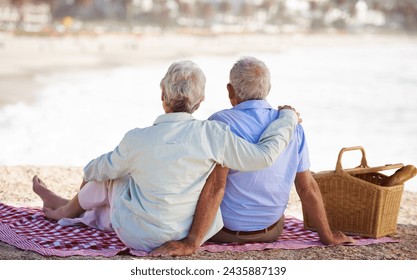 Elderly, couple and relax beach for picnic together for summer bonding or travel connection, outdoor or view. Old woman, man and back for vacation holiday at ocean in Hawaii for rest, peace or fun - Powered by Shutterstock