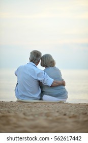 elderly couple rest at tropical beach