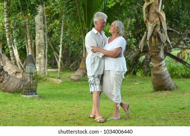 elderly couple running  on beach - Powered by Shutterstock