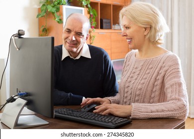 Elderly Couple Set Up A Web Camera For Video Calls At Home