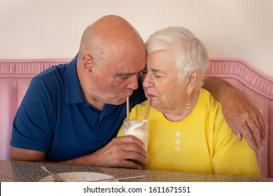 Elderly Couple Sharing Ice Cream At Soda Shop
