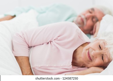Elderly Couple Sleeping In Bed