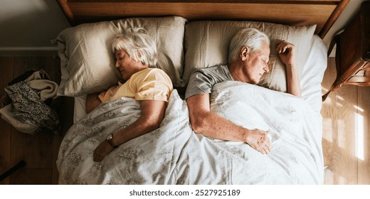 Elderly couple sleeping in bed at home. Peaceful rest for elderly man and woman. Senior couple enjoying sleep. Cozy bedroom for elderly pair. Restful sleep for seniors in a bed in their home. - Powered by Shutterstock