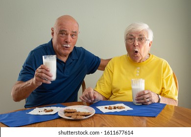 Elderly Couple Surprised While Eating Cookies And Milk