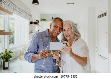 Elderly couple taking a selfie while having a wine - Powered by Shutterstock