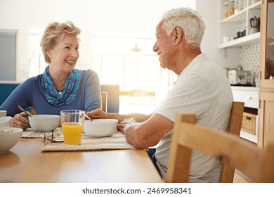 Elderly, couple and talking with eating at breakfast in dining room for nutrition, healthy meal and retirement. Senior, people and smile in home with conversation, relax or morning routine at table - Powered by Shutterstock