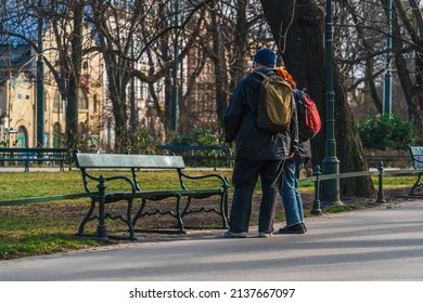 An Elderly Couple Of Tourists On Vacation Looking At A City Map On Their Phone On A Sunny Day In Early Spring