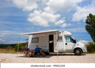 Elderly Couple Travel By Camping Car