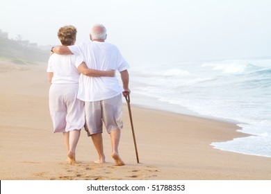 Elderly Couple Walking On Beach