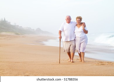 Elderly Couple Walking On Beach