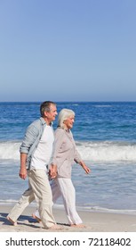 Elderly Couple Walking On The Beach