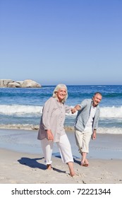 Elderly Couple Walking On The Beach