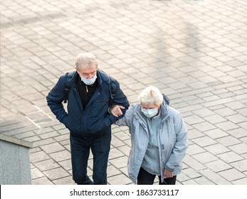 Elderly Couple Walks Together.Older Woman And Man Wearing Protective Face Masks,walking Arm In Arm Together During  COVID-19 Epidemic.Istanbul,Turkey.16 November 2020