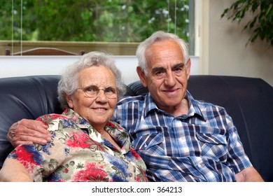 An elderly couple/grandparents.