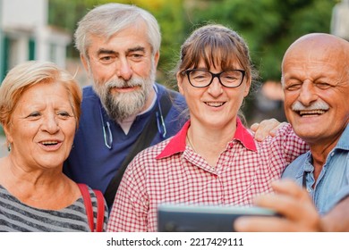 Elderly Couples Taking Selfie With Smartphone - Old Friends Reunion Having Fun Outdoors With Each Other