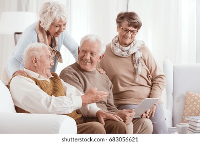 Elderly couples using technology while enjoying each others company - Powered by Shutterstock