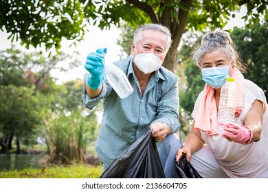 Elderly couples volunteers do community service by collecting trash and plastic bottles in the park. Concepts about saving the planet and reducing global warming. - Powered by Shutterstock