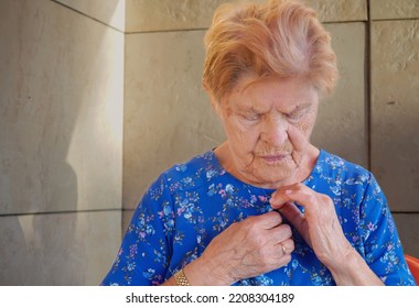 Elderly Disabled Woman Getting Dressed. Apraxia. Loneliness In Old Age