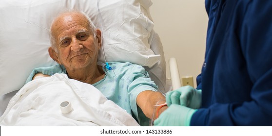 Elderly Eighty Plus Year Old Man Recovering From Surgery In A Hospital Bed.