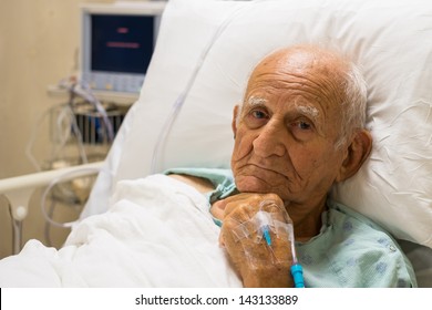 Elderly eighty plus year old man recovering from surgery in a hospital bed. - Powered by Shutterstock