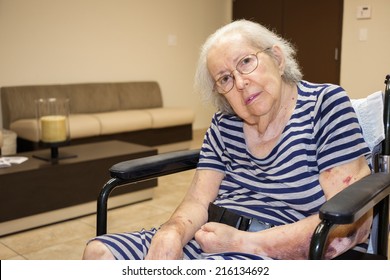 Elderly Eighty Plus Year Old Handicap Woman In A Medical Office Setting.