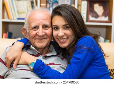 Elderly eighty plus year old man with granddaughter in a home setting. - Shutterstock ID 254980588