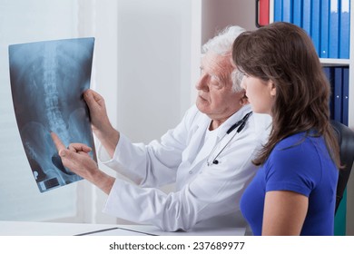 Elderly family doctor and his patient's X-ray image - Powered by Shutterstock