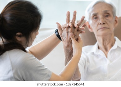 Elderly female patient suffer from numbing pain in hand,arthritis,tendon inflammation,stiffness of the joints,asian senior woman get a palm finger massage to treat beriberi,numbness fingertip concept - Powered by Shutterstock