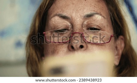 Elderly Gaze - Senior Woman Reads Online Content via Cellphone, Digital Reader, Close-up of Senior Lady Browsing on Mobile with Glasses