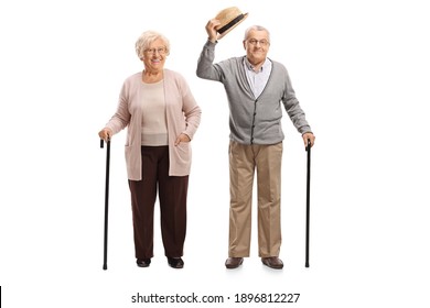Elderly gentleman greeting with hat and standing with an elderly woman isolated on white background