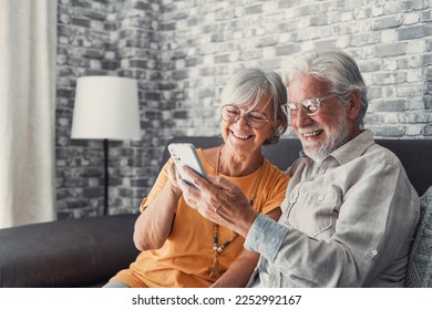 Elderly grandfather and grandmother spend time having fun using smartphone apps, middle-aged wife enjoy online entertainments, taking selfie with old husband, older generation and modern tech concept
