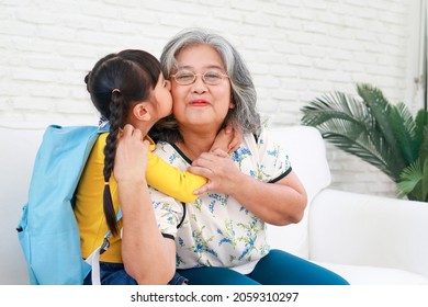 elderly grandmother with cute little granddaughter live at home together. Grandma sent her granddaughter to go to school in the morning. child education concept - Shutterstock ID 2059310297