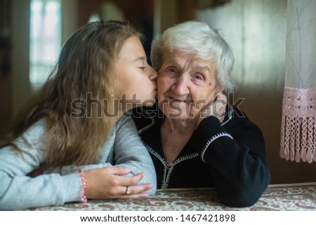 Similar – Young woman talking to elderly woman in wheelchair