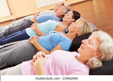 Elderly group doing neditation and relexation in a fitness center - Powered by Shutterstock