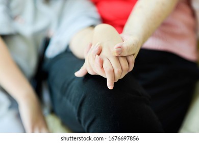 Elderly Hand Holding Child's Hand.Old And Young Hands Bonding.Two People Sitting Down While Wrapping Fingers.Grandchild And Grandmother.Bonding Time.