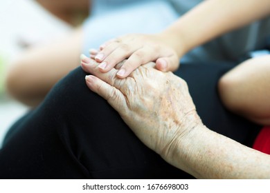 Elderly Hand Holding Child's Hand.Old And Young Hands Bonding.Two People Sitting Down While Wrapping Fingers.Grandchild And Grandmother.Bonding Time.