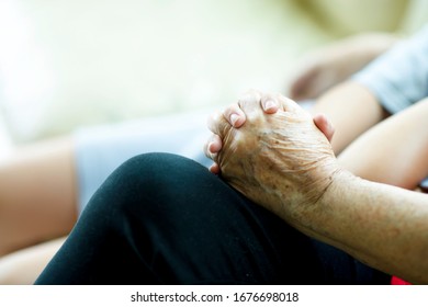 Elderly Hand Holding Child's Hand.Old And Young Hands Bonding.Two People Sitting Down While Wrapping Fingers.Grandchild And Grandmother.Bonding Time.