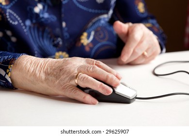 An Elderly Hand On A Computer Mouse