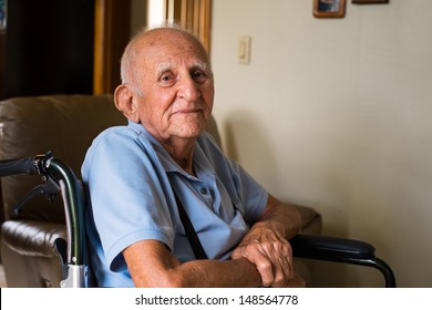 Elderly Handicapped Eighty Plus Year Old Man In A Wheel Chair In A Home Setting.