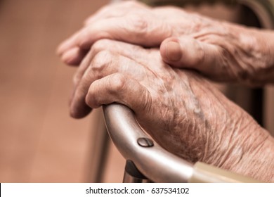 Elderly hands on a walker