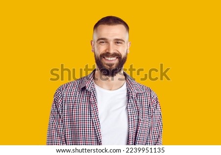 Elderly happy mustache bearded man 40s in plade shirt isolated on plain pastel light yellow background in studio. People lifestyle concept. Positive close up portrait.