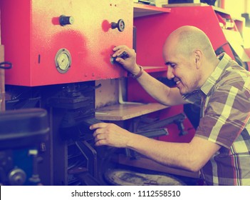 Elderly Happy Specialist Fixing Heel Taps Of Shoes On Machine