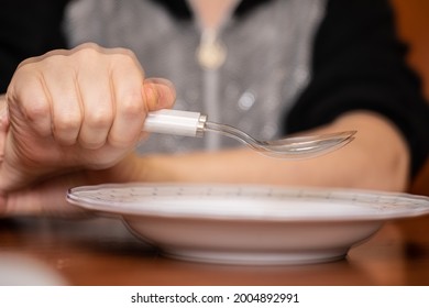 Elderly Holding Spoon And Hands Tremor While Eating, Cause Of Hands Shaking Include Parkinson Disease, Stroke