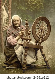 Elderly Irish Spinner working outdoors at her spinning wheel in the late 19th century. Galway County, ca. 1900.