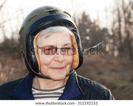 Elderly lady in army helmet