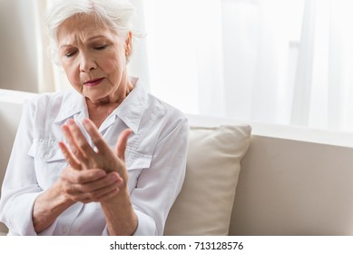 Elderly lady is enduring strong ache