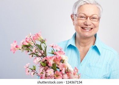 Elderly Lady Holding Flowers At Mother's Day, Smiling.