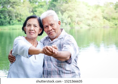 Elderly Lovers Holding Hands Dancing In The Garden Have Fun In Retirement Life. Senior Community Concepts