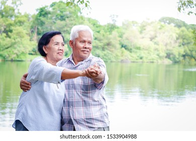 Elderly Lovers Holding Hands Dancing In The Garden Have Fun In Retirement Life. Senior Community Concepts