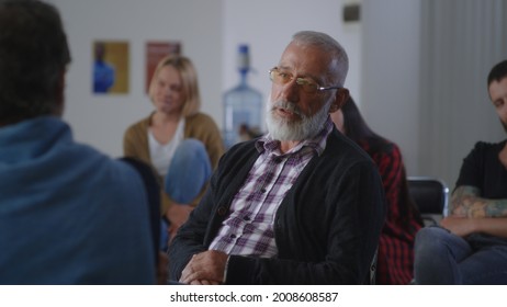 Elderly Male Addict Talking During AA Meeting